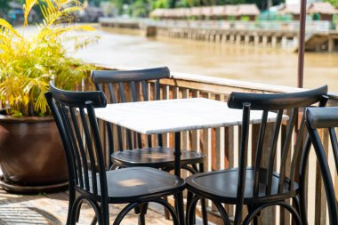 empty table and chair in restaurant with river view