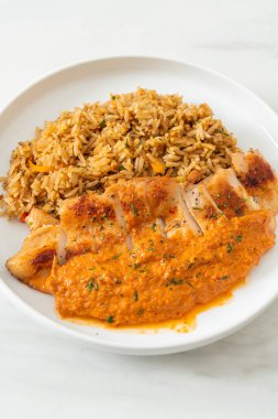 Kırmızı köri soslu ızgara tavuk bifteği ve pilav. Müslüman usulü.