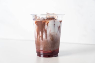 iced chocolate with milk and strawberry syrup in glass