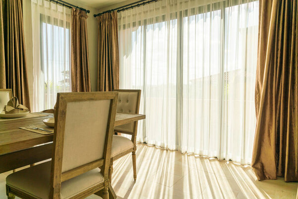 beautiful curtain with sunlight from glass window