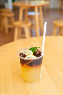 lemon with black coffee in take away glass