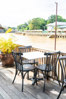 empty table and chair in restaurant with river view