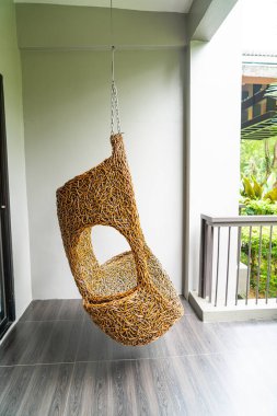 empty wicker swing on blacony for relaxing