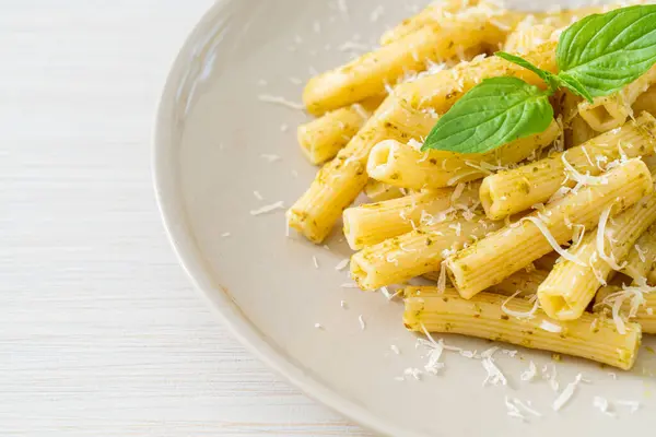 stock image pesto rigatoni pasta with parmesan cheese - Italian food and vegetarian food style