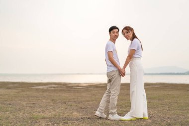 Happy young Asian couple in bride and groom t-shirt ready for marry and wedding celebrate