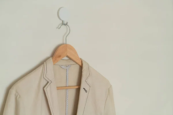 Beige Suit Hanging Wood Hanger Wall — стоковое фото
