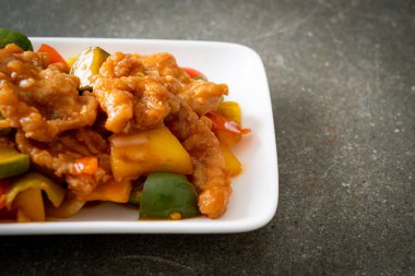 Kızarmış tatlı ve ekşi sosla domuz ve sebzeyi karıştır.