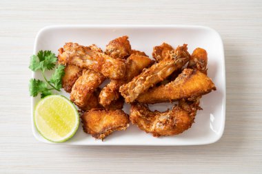 Fried Snapper Belly on white plate - Asian food style