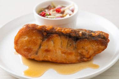 fried snapper fish with fish sauce and spicy salad - Asian food style