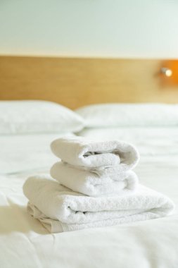 close-up white towel stack on bed