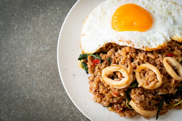 stock image fried rice with squid and basil topped fried egg in Thai style - Asian food style