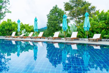 pool bed around swimming pool with mountain hill background - Holidays and vacation concept