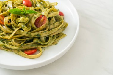 pesto soslu ve domatesli makarna vejetaryen ve vejetaryen yemek tarzı.