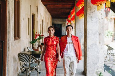 Happy young Asian couple love in Chinese traditional dresses - Red is the main color of the traditional festive that including wedding in China.