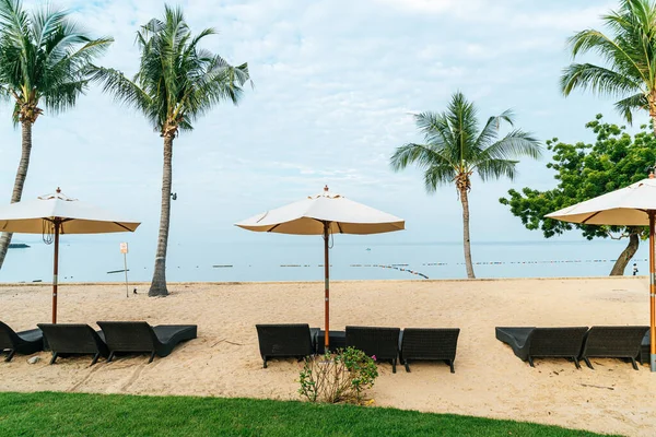 stock image empty beach chair with palm tree on beach with sea background