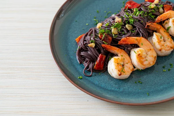 Stock image stir-fried black spaghetti with garlic and shrimps on plate