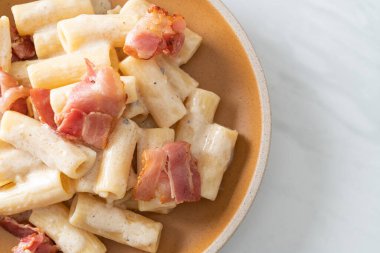 Beyaz soslu ve pastırmalı ev yapımı spagetti rigatoni makarna. İtalyan usulü.