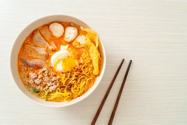 stock image egg noodles with pork and meatball in spicy soup or Tom Yum Noodles in Asian style