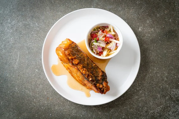 fried snapper fish with fish sauce and spicy salad - Asian food style