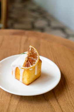 lemon pound cake on white plate in cafe and restaurant