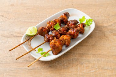 Izgara tavuk şişi. Tabakta baharat ve şifalı otlar var.