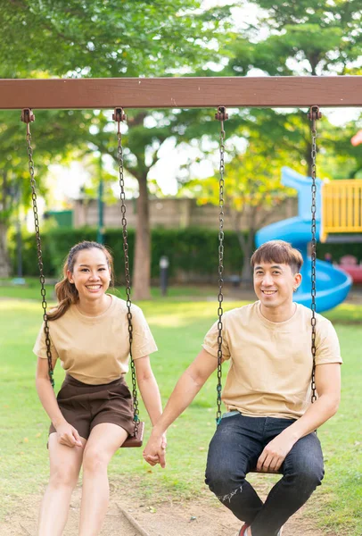 Asian Couple Love Play Swing Kids Playground — стоковое фото