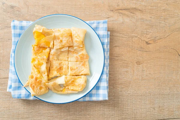 Stock image fried roti with egg and sweetened condensed milk