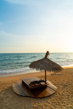 beach chair and umbrella with sea beach background at sunset time - Holidays and vacation concept