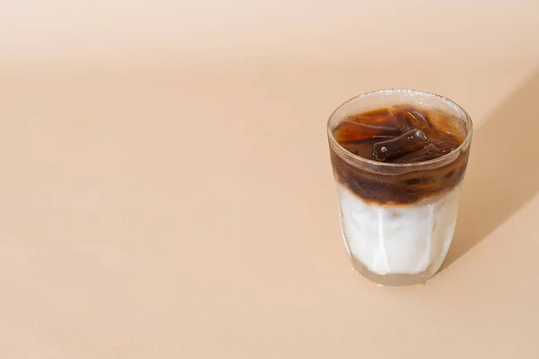 iced black coffee with milk layer in glass
