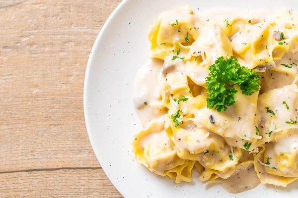 stock image tortellini pasta with mushroom cream sauce and cheese - Italian food style