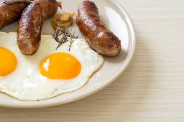 Kahvaltıda omlet ve kızarmış domuz sosisi.
