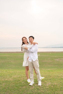 Happy young Asian couple in bride and groom clothing ready for marry and wedding celebrate