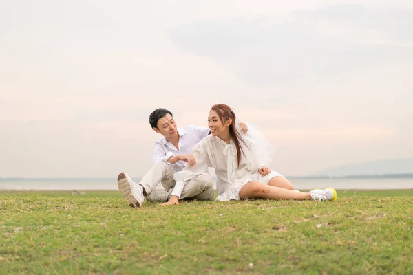 Happy young Asian couple in bride and groom clothing ready for marry and wedding celebrate