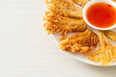 Kızarmış enoki mantarı ya da baharatlı soslu altın iğneli mantar - vejetaryen yemek tarzı.