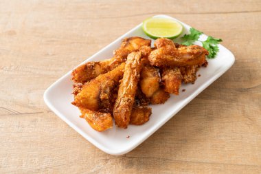 Fried Snapper Belly on white plate - Asian food style