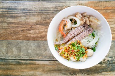 spicy seafood noodles bowl in Thai style - Tom Yum Noodles