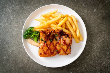 grilled chicken steak with potato chips or french fries on white plate