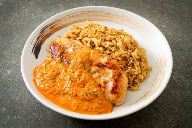 Kırmızı köri soslu ızgara tavuk bifteği ve pilav. Müslüman usulü.