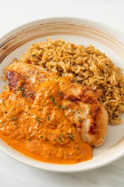 Kırmızı köri soslu ızgara tavuk bifteği ve pilav. Müslüman usulü.