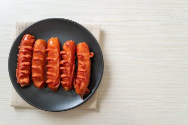 Siyah tabakta kızarmış sosis şişi.