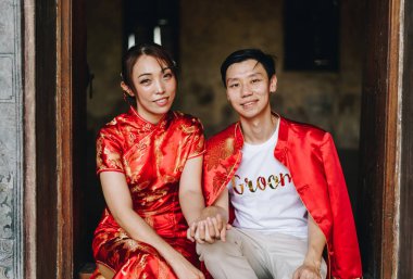 Happy young Asian couple love in Chinese traditional dresses - Red is the main color of the traditional festive that including wedding in China.