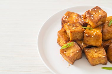 Beyaz susamlı kızarmış tofu ve teriyaki sosu. Vejetaryen ve vejetaryen yemek tarzı.