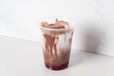 iced chocolate with milk and strawberry syrup in glass