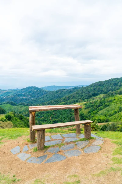 empty wood bar and chair with mountain hill background