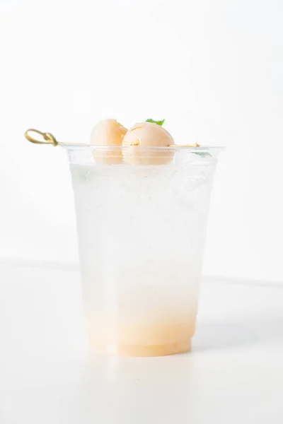 lychee with soda in glass with fresh lychee on top
