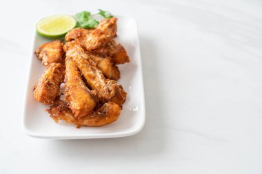 Fried Snapper Belly on white plate - Asian food style