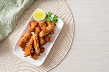 Fried Snapper Belly on white plate - Asian food style