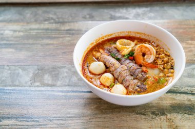 spicy seafood noodles bowl in Thai style - Tom Yum Noodles