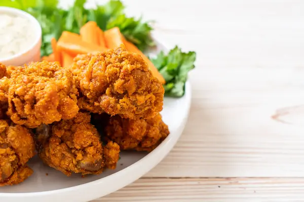 fried spicy chicken wings with vegetable