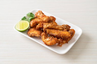 Fried Snapper Belly on white plate - Asian food style